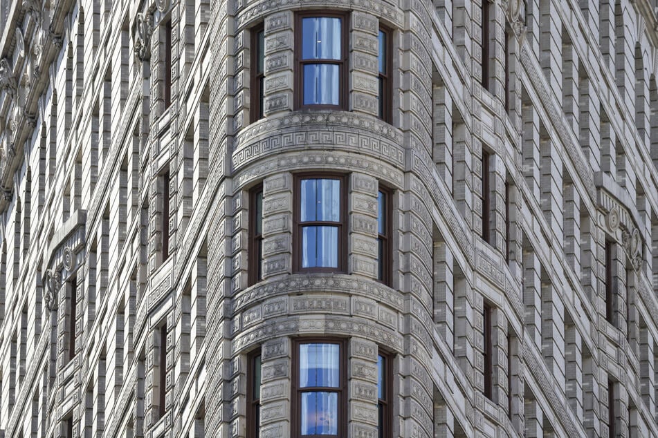 New York City's Flatiron Building is seen as scaffolding removal began during its conversion from office to residential use on April 17, 2026.