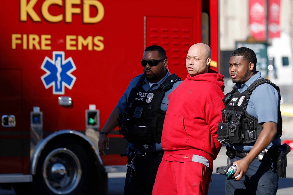 A man is detained by law enforcement following the shooting at Union Station during the Kansas City Chiefs Super Bowl LVIII victory parade on Wednesday.