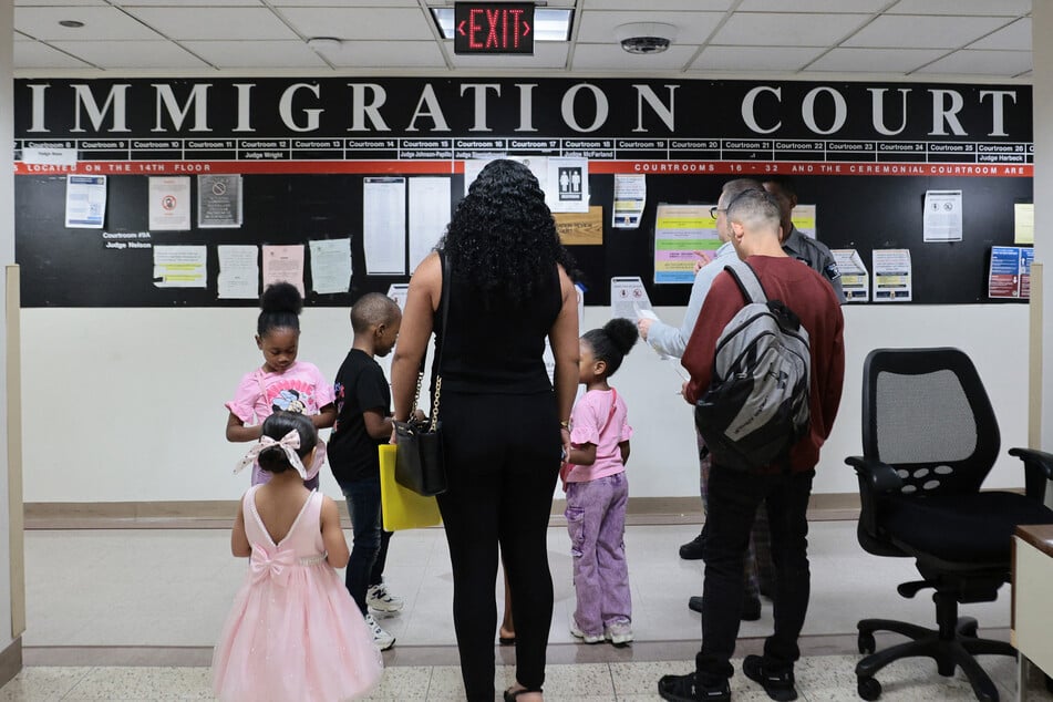 Families arrive for a court hearing in immigration court at the Jacob K. Javits Federal Building in New York on July 31. The Trump administration has moved to hinder legal services to unaccompanied migrant minors, making it easier to deport them.
