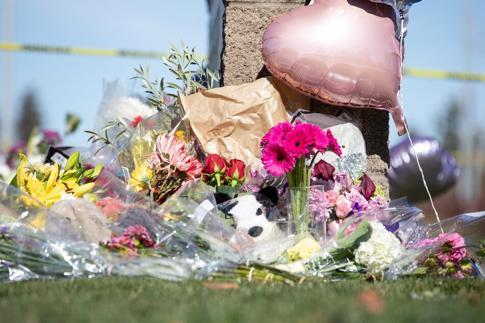 Flowers, toys, and other items are left at a vigil outside of Silver Rail Elementary School in Bend, Oregon, on October 16, 2026.