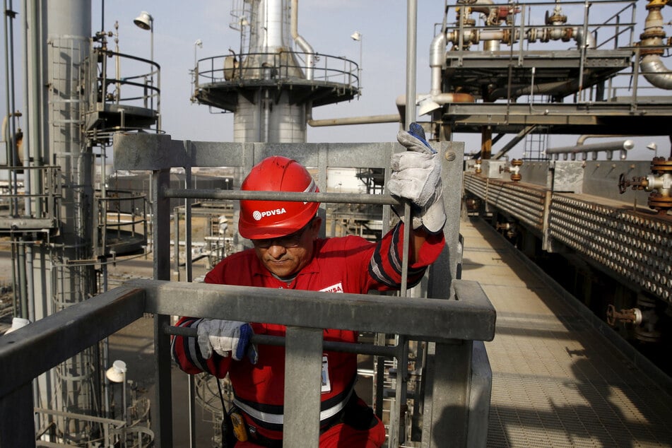 An oilfield worker walks down the stairs at PDVSA's Jose Antonio Anzoategui industrial complex in the Venezuelan state of Anzoategui.