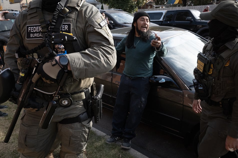 Federal agents stop a resident and request to see proof of citizenship on November 6, 2025 in Chicago, Illinois. The man produced the required documents and was allowed to go free.
