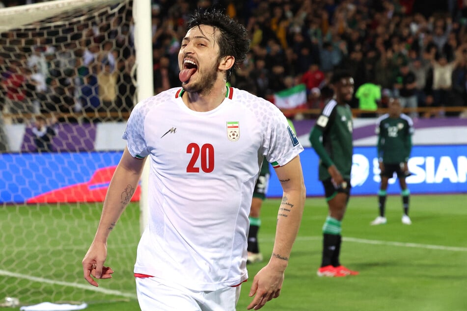 Iran's forward Sardar Azmoun celebrates after scoring their first goal during the FIFA World Cup 2026 Asia zone qualifiers group A match against the UAE at the Azadi Sports Complex in Tehran on March 20, 2025.