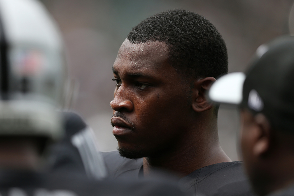Aldon Smith warms up with the Oakland Raiders before playing the Cincinnati Bengals in their NFL season opener on September 13, 2015.