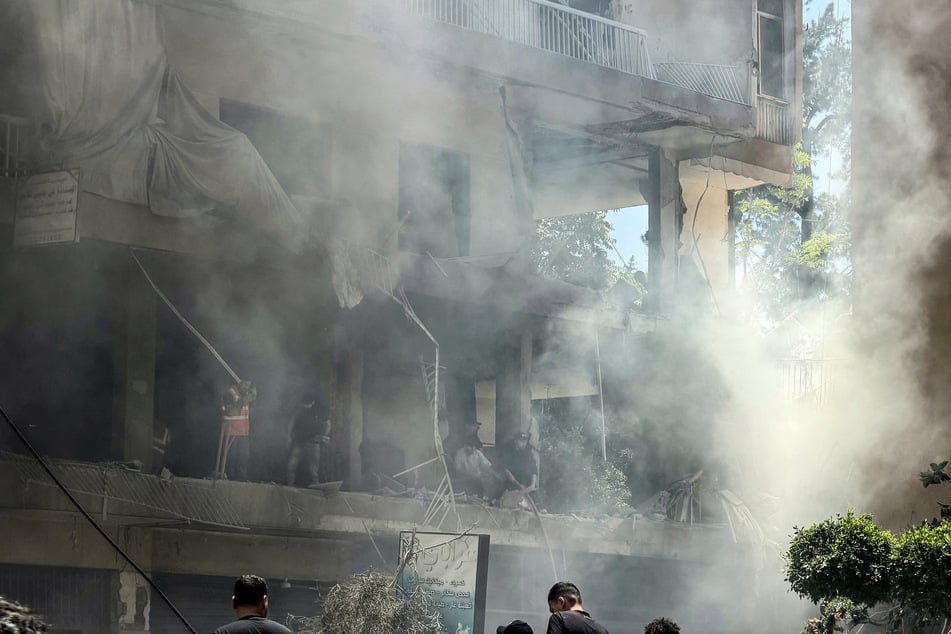 People look for survivors at the site of an Israeli airstrike that targeted a building in Beirut’s southern suburbs on June 14, 2026.