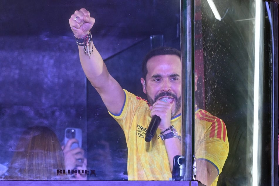 Colombia's presidential candidate for the Defensores de la Patria movement, Abelardo de la Espriella, speaks to supporters from behind bullet-proof glass following the preliminary results of the presidential runoff election at the Ventana al Mundo monument in Barranquilla, Colombia, on June 21, 2026.