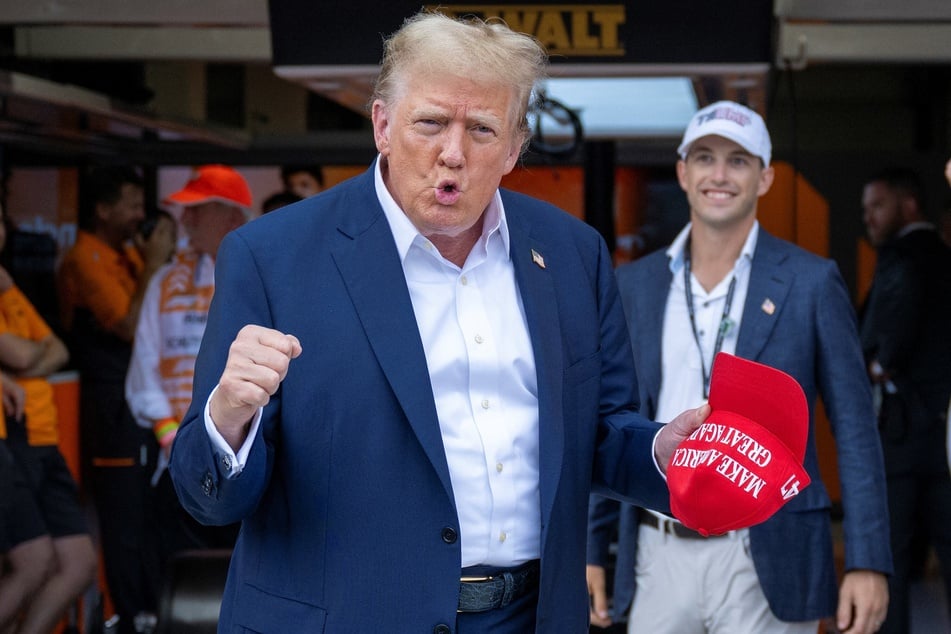 2024 presidential candidate Donald Trump gesturing to photographers as he visited the Miami International Autodrome in Miami Gardens, Florida, on Sunday.