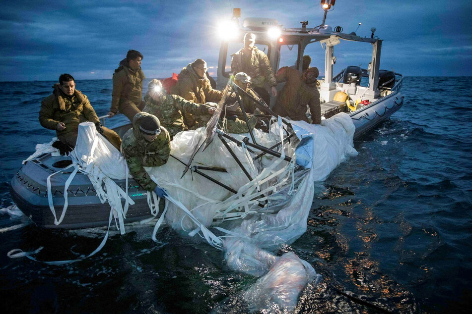 Sailors assigned to Explosive Ordnance Disposal Group 2 recover a suspected Chinese high-altitude surveillance balloon that was downed over US territorial waters off the coast of Myrtle Beach, South Carolina.