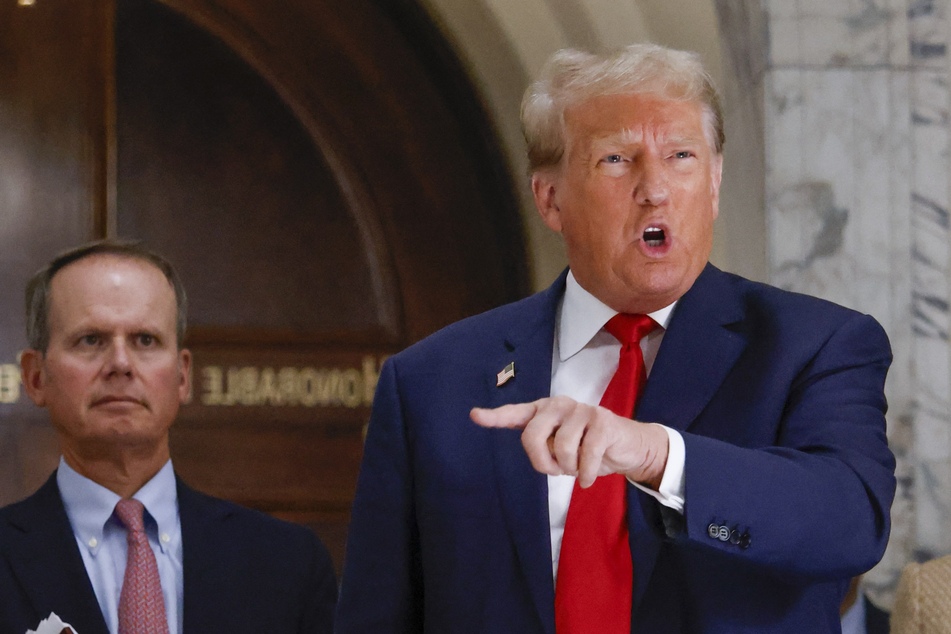Donald Trump addresses the press during a lunch break on the third day of his New York civil trial.
