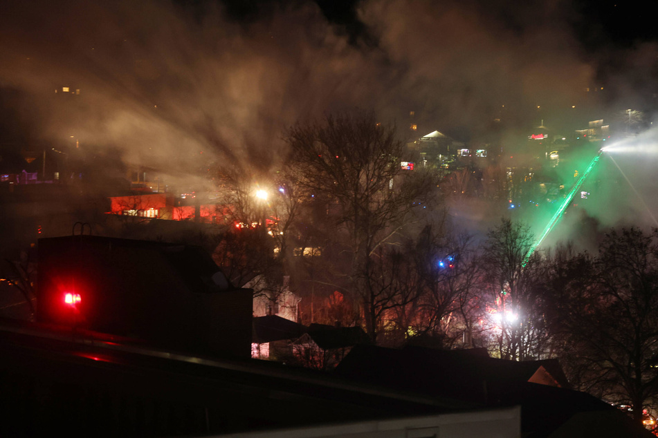 A fire breaks out after an explosion, caused by an Arlington homeowner firing a flare gun inside, as police went to search the house on December 4, 2023.
