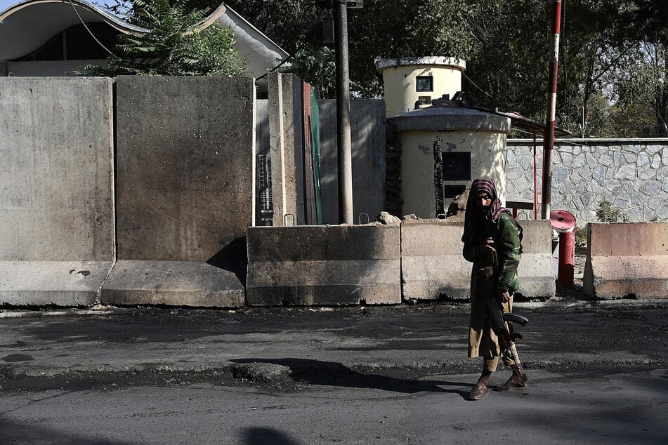 A Taliban fighter stands guard outside the Sardar Mohammad Dawood Khan military hospital in Kabul on November 3, 2021, a day after an attack on Kabul's main military hospital claimed by the Taliban's hardline rivals the Islamic State-Khorasan (ISIS-K).
