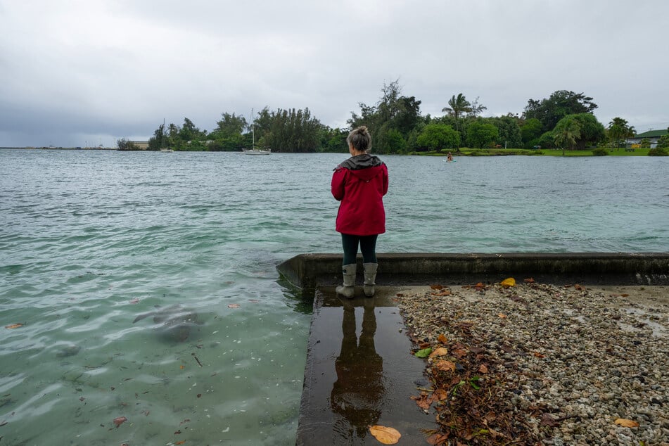 A resident looks on as ocean waters started to rise due to the approach of Lala at Reed's Bay in Hilo, Hawaii, on August 14, 2026.