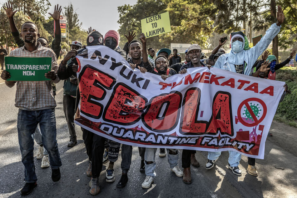 Protesters hold a banner and chant slogans as they march during a demonstration against a US-built Ebola quarantine center in Nanyuki on June 9, 2026.