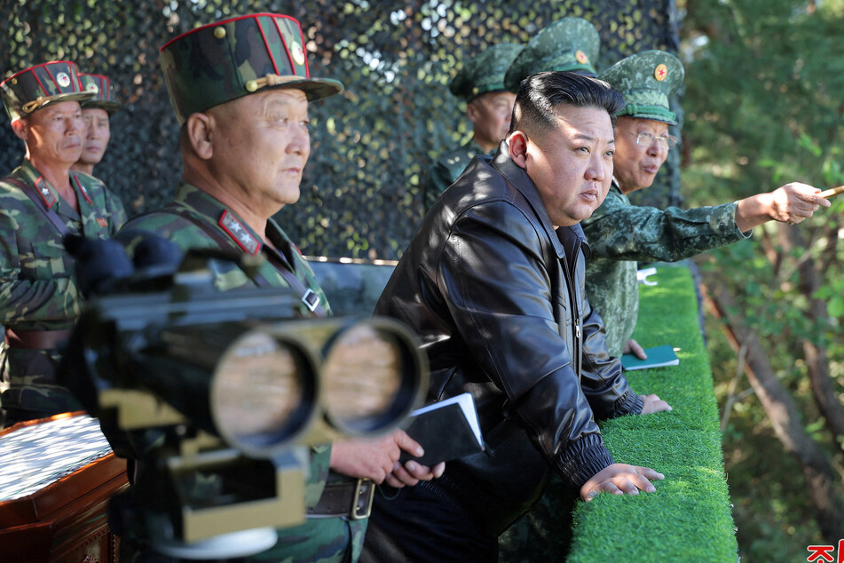 Kim Jong-un (c.) said North Korea would not hesitate to use nuclear weapons against Seoul, whose "existence" would be "impossible" if Pyongyang's sovereignty were threatened.
