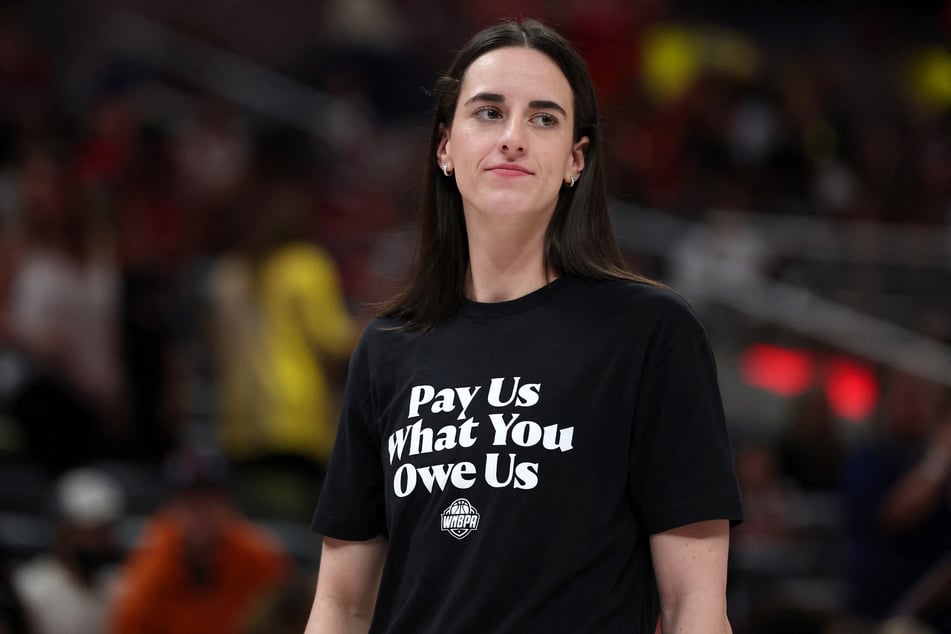Caitlin Clark of the Indiana Fever wears a shirt saying "Pay Us What You Owe Us" prior to the 2025 AT&T WNBA All-Star Game at Gainbridge Fieldhouse on July 19, 2025.