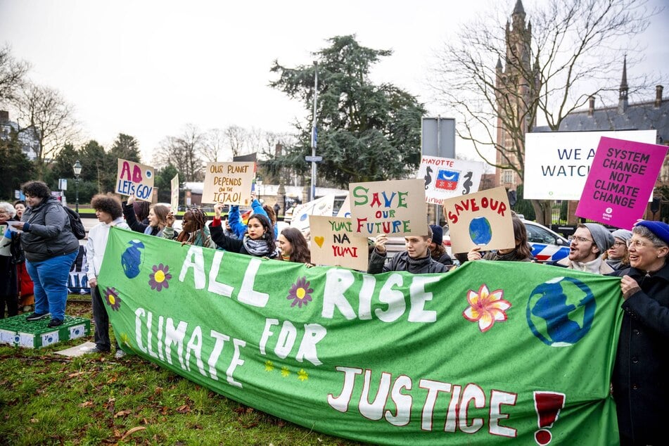 Climate activists demonstrate in front of the International Court of Justice in The Hague, Netherlands on December 2, 2024.