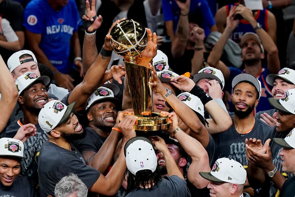 The New York Knicks hoist the trophy after defeating the San Antonio Spurs in game five of the 2026 NBA Finals at Frost Bank Center.