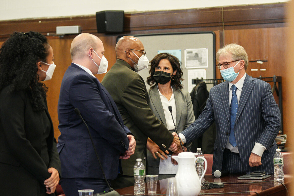 Muhammad Aziz (c.) was exonerated in the murder of Malcolm X after spending 19 years behind bars.