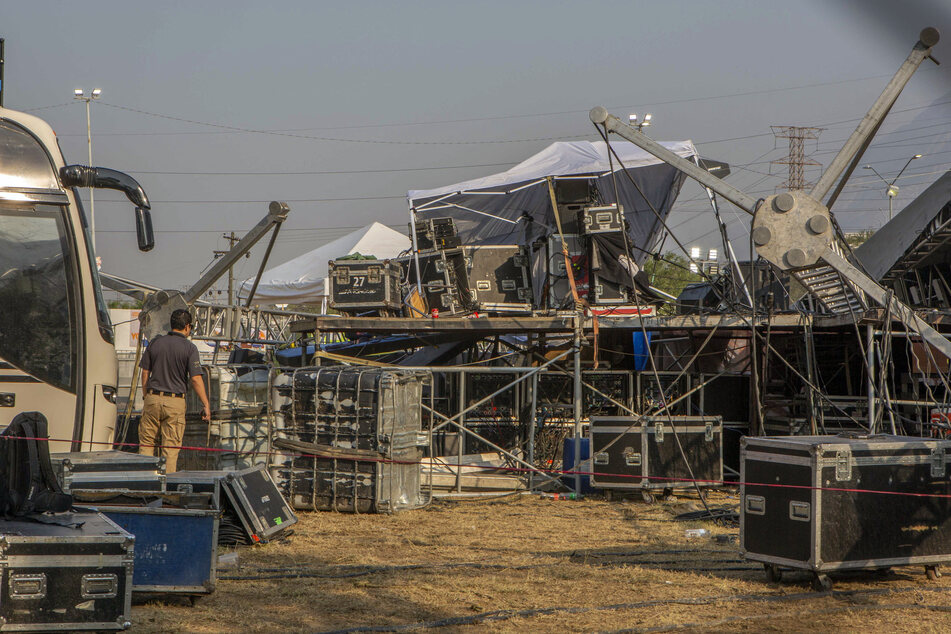 A member of forensic services inspects the area where a stage collapsed the day before.
