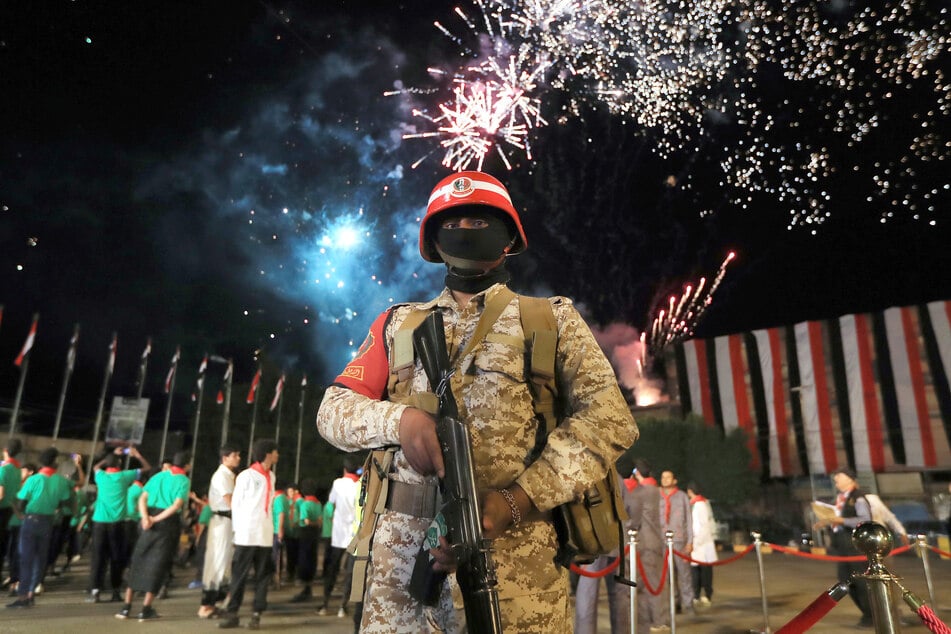A security officer stands guard during a ceremony organized by Houthi authorities to mark the 12th anniversary of takeover of Yemeni capital, in Sanaa on September 20, 2026.