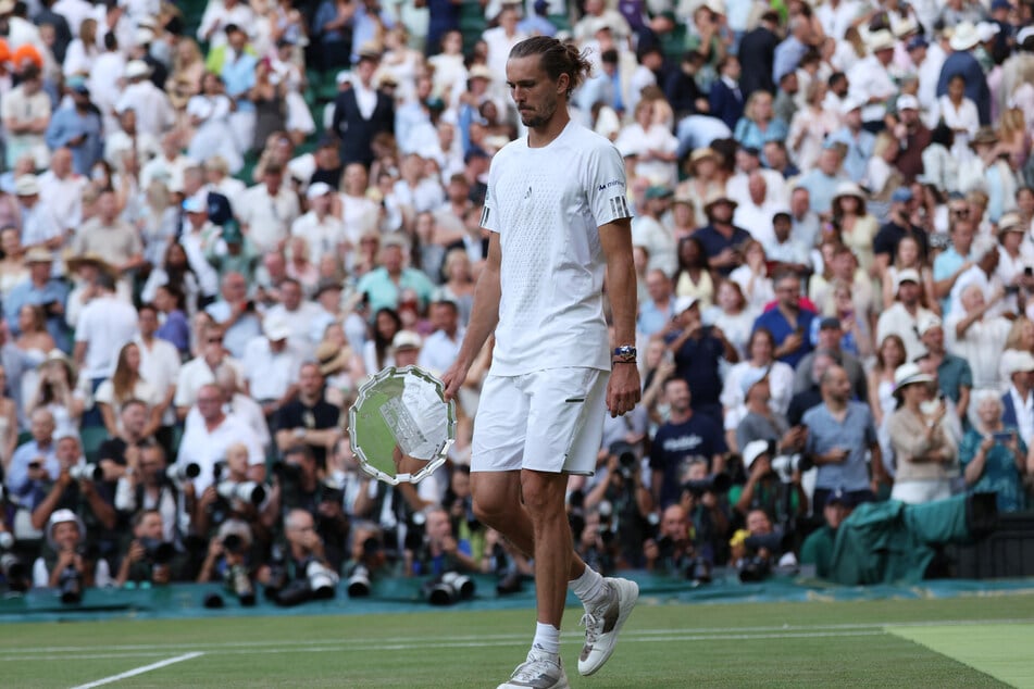 Alexander Zverev with the runner-up trophy after his Wimbledon final match against Jannik Sinner.