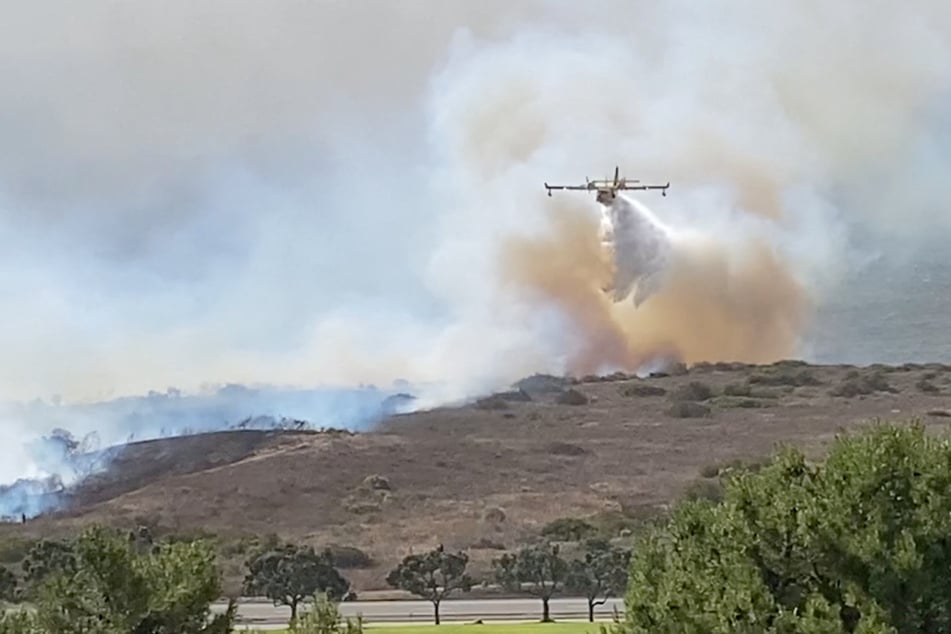 Mountain Fire rages on uncontrolled as thousands urged to flee areas near LA