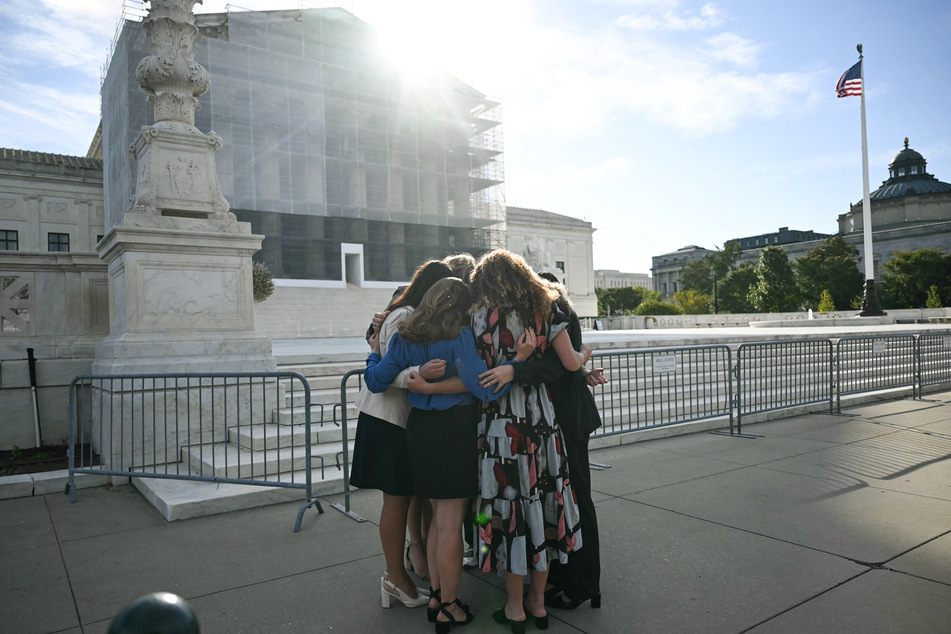 Members of the group "Concerned Women for America" pray outside the US Supreme Court as the Court hears oral arguments in Chiles v. Salazar, a landmark case on "conversion therapy," on Tuesday, in Washington, DC.