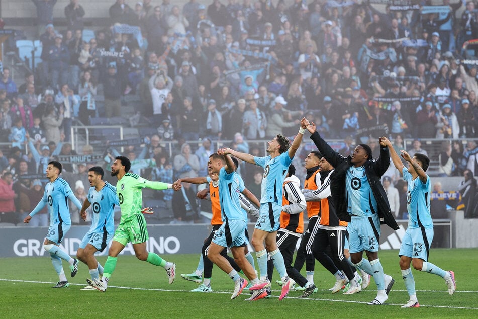Minnesota United FC players celebrate their teams win against the St. Louis City SC after the game at Allianz Field.