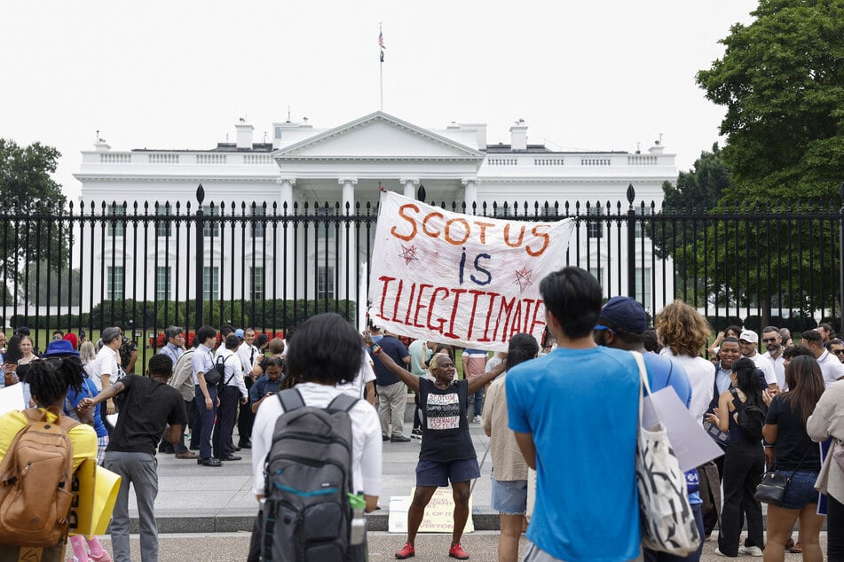 People gathered in front of the White House to protest the Supreme Court's landmark rulings on education and the treatment of LGBTQ+ people.