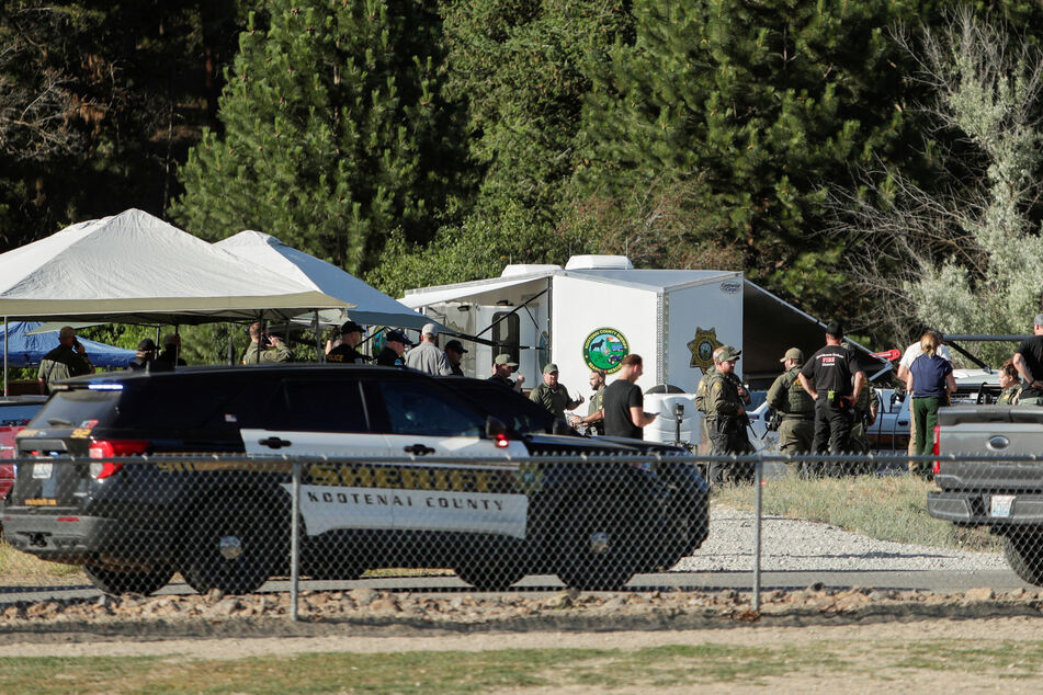 Law enforcement officers gather at Cherry Hill Park after multiple firefighters were attacked when responding to a fire in the Canfield Mountain area outside Coeur d’Alene, Idaho, on June 29, 2025.