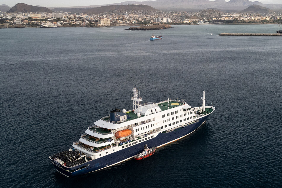This aerial view shows health personnel boarding the cruise ship MV Hondius, while stationary off the port of Praia on Wednesday.
