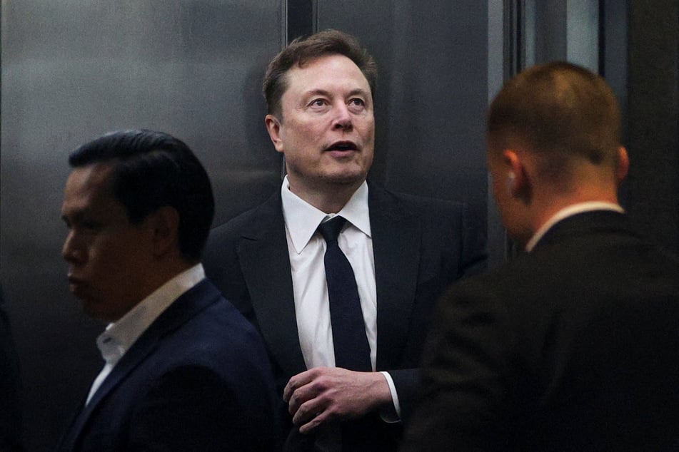 Elon Musk stands in an elevator to attend the trial in his lawsuit over OpenAI's for-profit conversion at a federal courthouse in Oakland, California, on April 30, 2026.