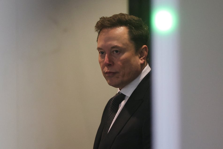Elon Musk walks to attend the trial in his lawsuit over OpenAI's for-profit conversion at a federal courthouse in Oakland, California, on April 29, 2026.