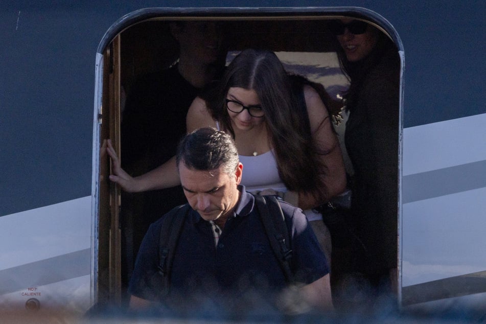 Brazilian Senator Flavio Bolsonaro disembarks from a plane after arriving at Opa-locka Executive Airport near Miami, Florida, on October 28, 2026. He insists he is Brazil's rightful leader despite losing the country's presidential election runoff.