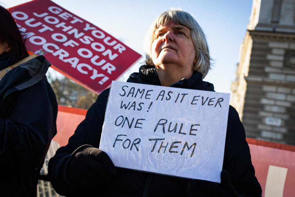 Protesters gathered outside Parliament in London as the Conservative government was rocked by scandal after scandal.
