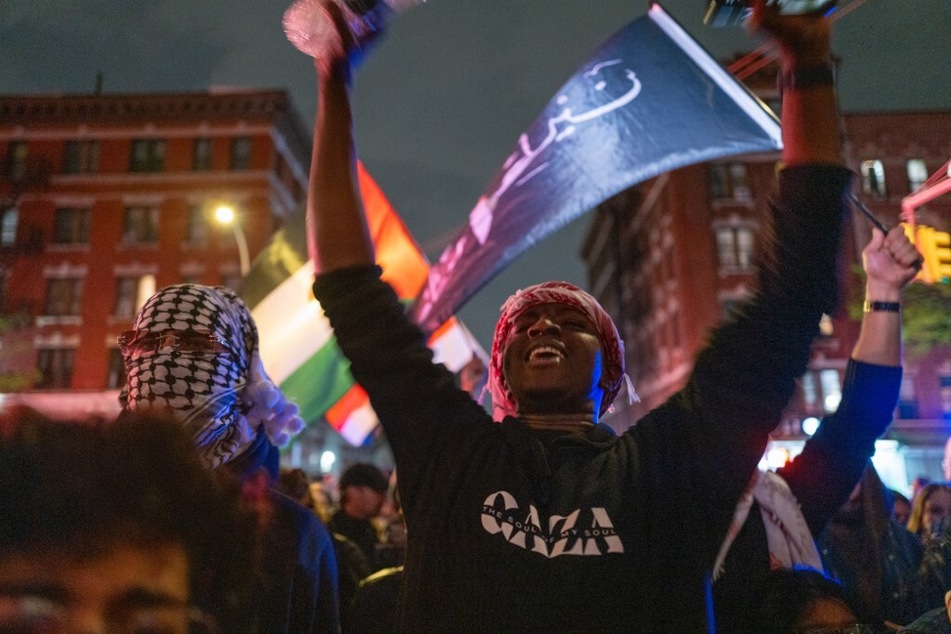 Protesters at the City College of New York raise Palestinian flags and peace signs as they confront militarized police on their campus.
