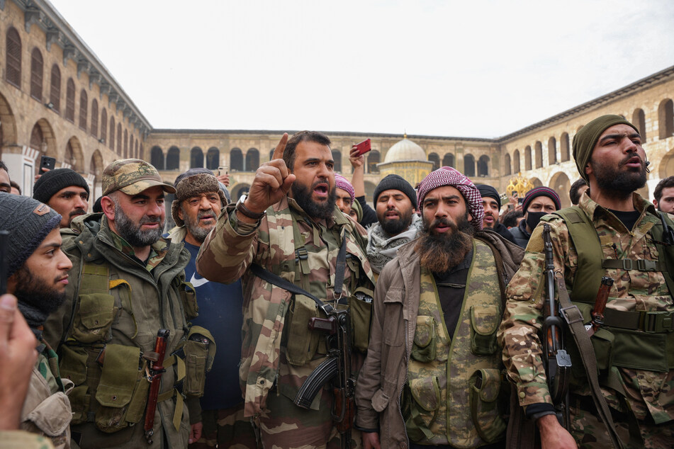 Syrian rebel fighters celebrated taking Damascus as President Bashar al-Assad's regime fell after 24 years.