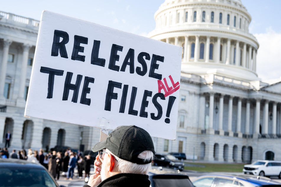 A protester holds a sign calling for the release of all the Jeffrey Epstein case files outside the US Capitol in Washington DC on November 12, 2025.