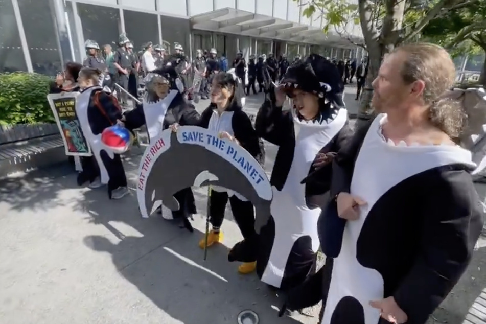 Climate activists clad as orcas rally outside the Citibank headquarters in New York City.