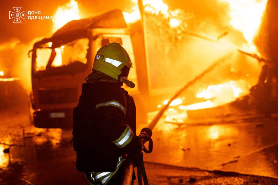 This handout picture by Ukrainian State Emergency Service shows a firefighter extinguishing a fire following an aerial attack by Russia in Ukraine on September 27, 2026.