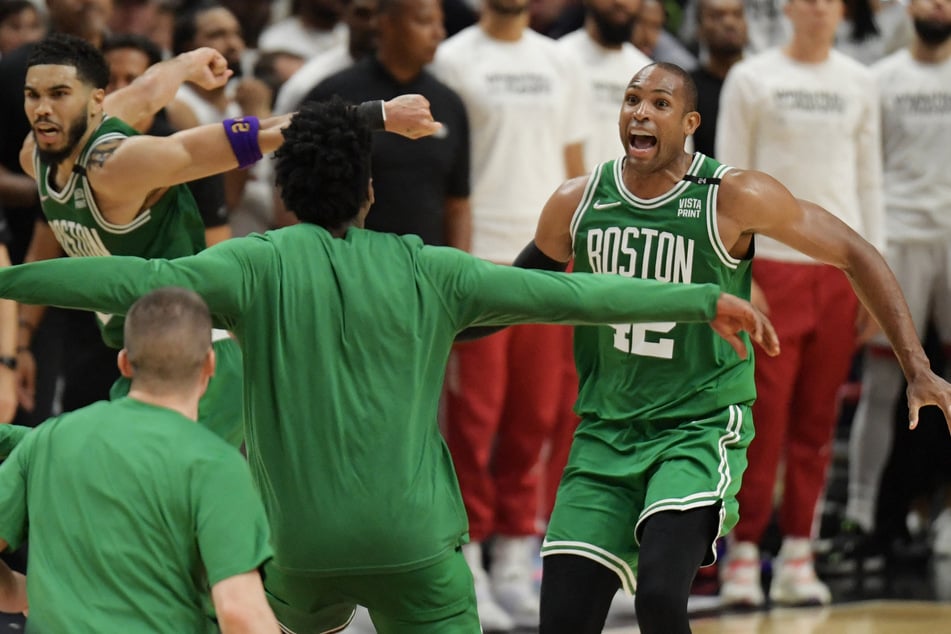 Jayson Tatum (l.) and Al Horford (r.) celebrate the Celtics' Game 7 win in Miami that sent them to the NBA Finals.