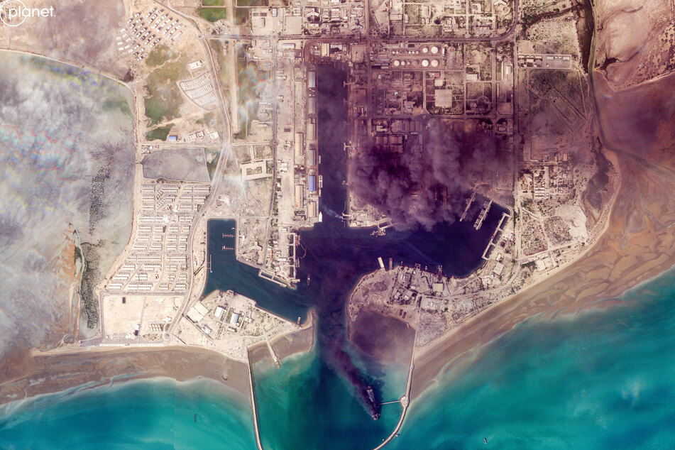 This handout satellite image taken by 2026 Planet Labs PBC on March 2, 2026 shows smoke billowing following an explosion from the port of Bandar Abbas along the strait of Hormuz.