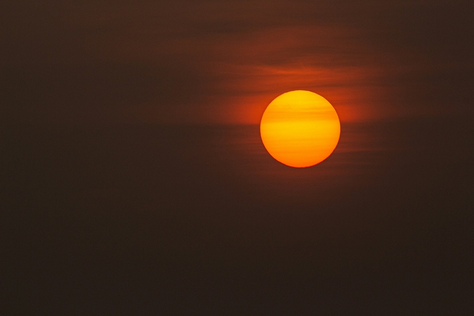 The Earth may not be engulfed by the expanding fireball of the dying Sun, which has long been assumed to be our home planet's ultimate fate, according to scientists.