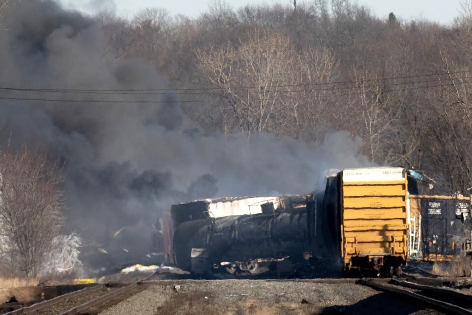 Smoke rises from a derailed cargo train in East Palestine, Ohio, on February 4, 2023.