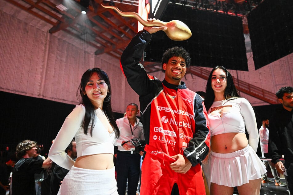 Tristan Mykel of USC holds a golden sperm trophy after winning the Sperm Racing competition championship in Los Angeles, California on Friday.
