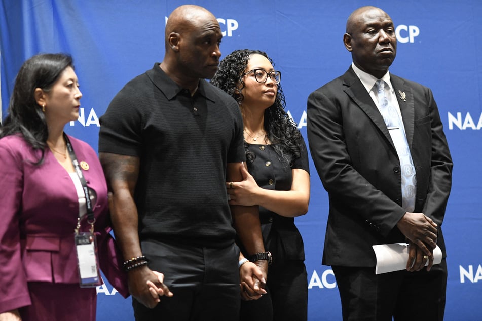 Attorney Liza Park (l.), Nolan Wells' parents Elmore and Christine Wonsley (c.), and attorney Ben Crump appear at a news conference on July 22, 2026. Crump announced on September 24, 2026, that his team will release the full independent autopsy, toxicology, and forensic reports next week.