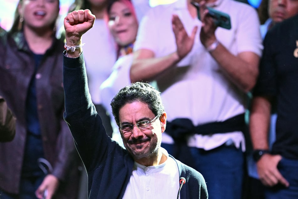 Colombia's presidential candidate for the ruling Pacto Historico party, Ivan Cepeda, raises his fist after the first results of the presidential election runoff at the Tequendama Hotel in Bogota on June 21, 2026.