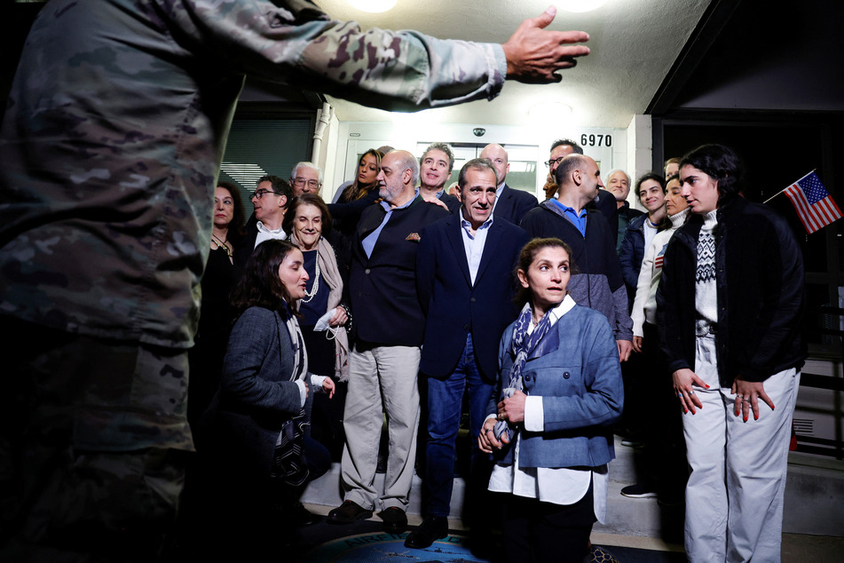 The former detainees take a group photo after their arrival at an airfield in Fort Belvoir, Virginia.