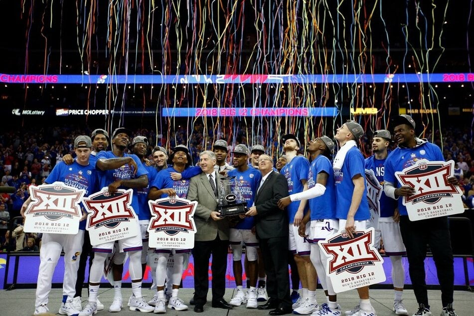 The Kansas Jayhawks celebrate after winning the Big 12 Conference Championships.