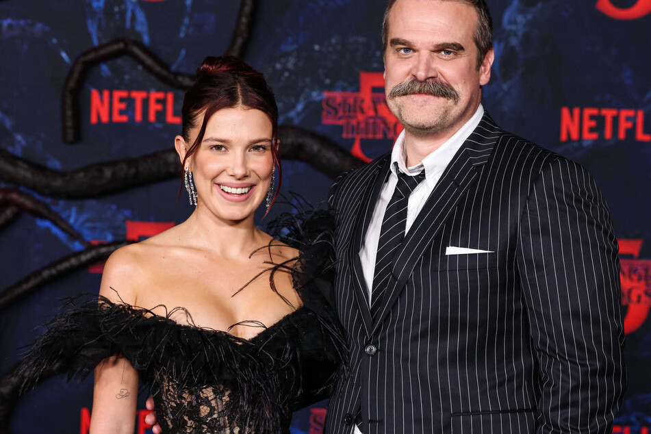 Millie Bobby Brown (l) and David Harbour (r) both skipped the final Stranger Things event in NYC following Millie's harassment suit against her co-star.